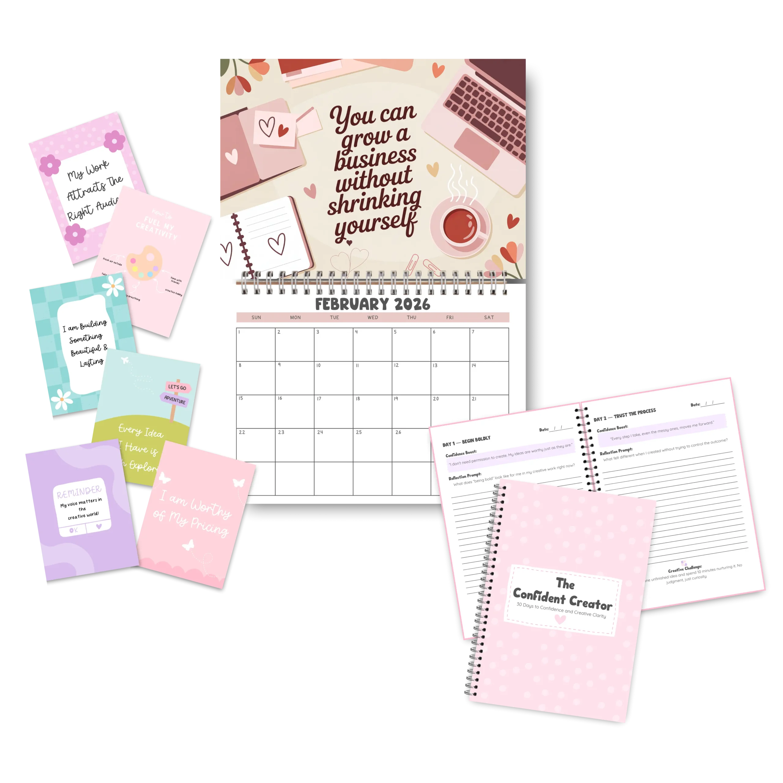Flat lay of a pink-themed business and mindset stationery set, including a February 2026 wall calendar with the quote "You can grow a business without shrinking yourself," motivational affirmation cards, and an open workbook titled "The Confident Creator." The materials emphasize self-worth, creativity, and confidence in business.